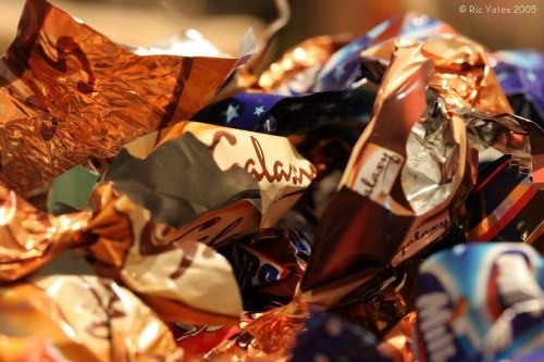Workers handling waste bins with protective clothing